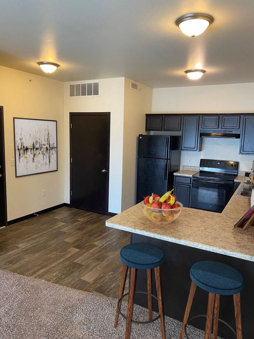 a view of the kitchen and living room in a one bedroom apartment at the staybridge suites