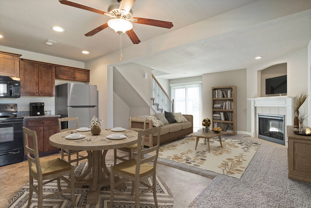 a living room with a dining room table and a fireplace