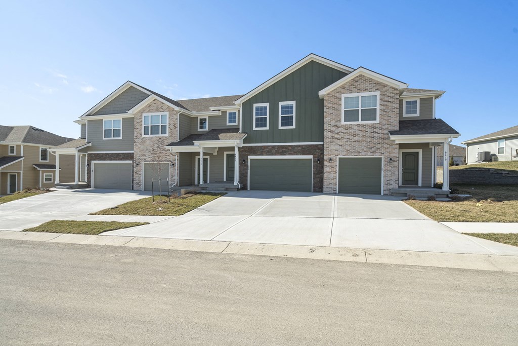 a large house with a sidewalk in front of it