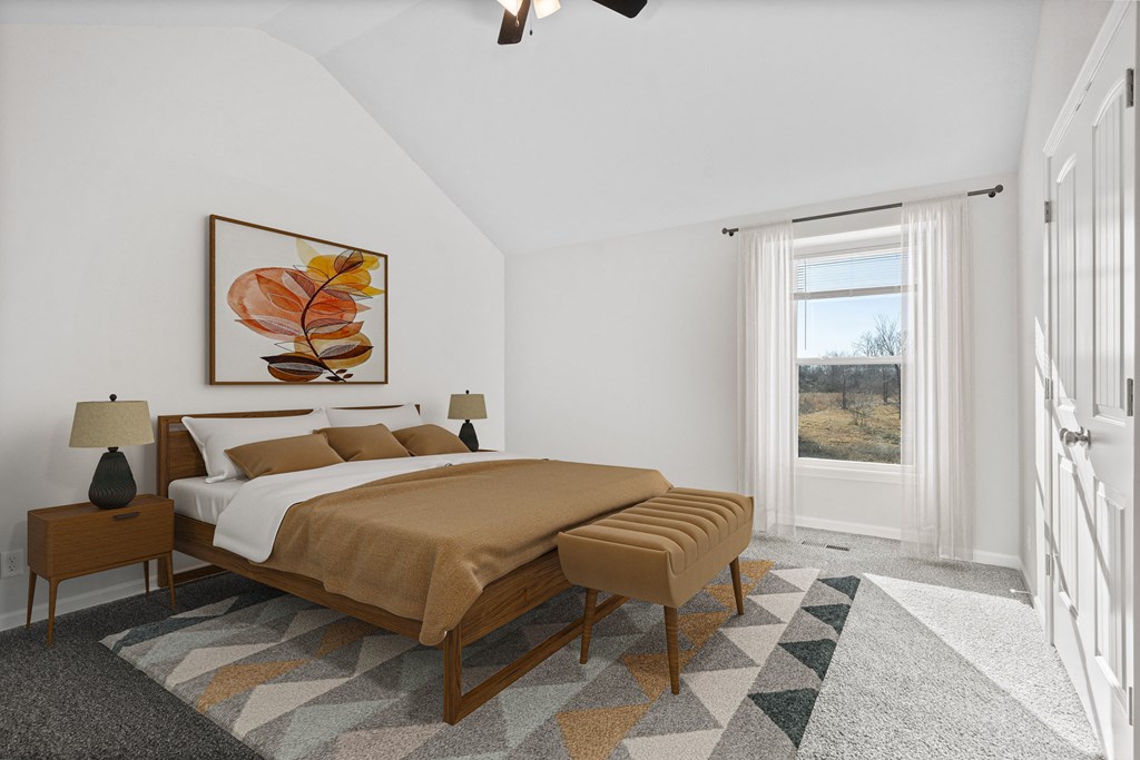 a bedroom with a bed and a painting on the wall