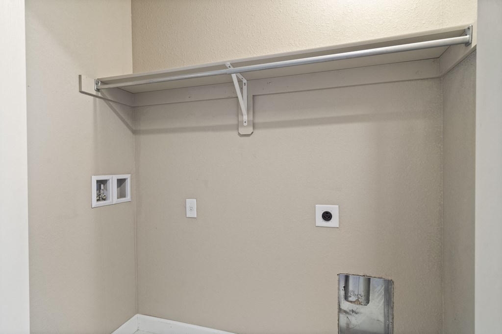 a room with a wall with a sensor and a pipe on the wall