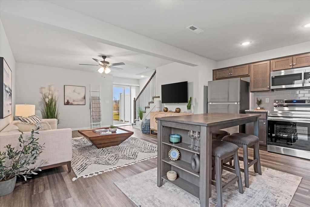 an open living room with a kitchen and a living room