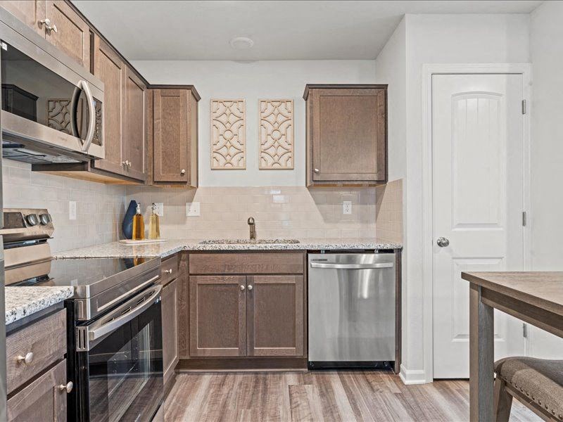 a kitchen with stainless steel appliances and wooden cabinets
