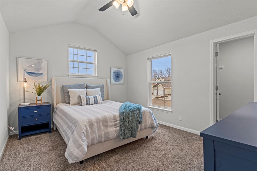 a bedroom with a bed and a ceiling fan