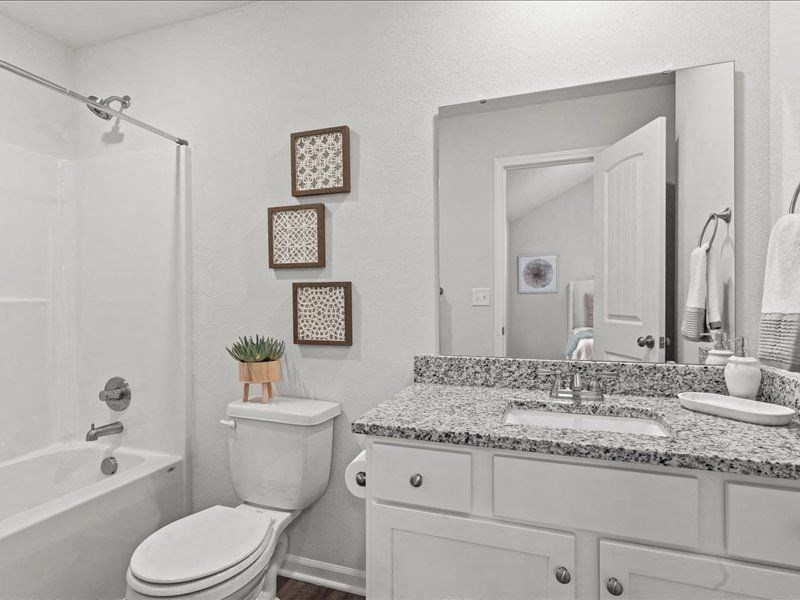 a bathroom with a sink toilet and a mirror