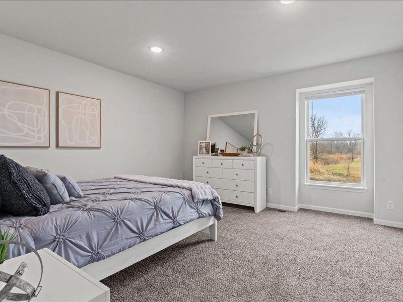 a bedroom with a bed and a dresser