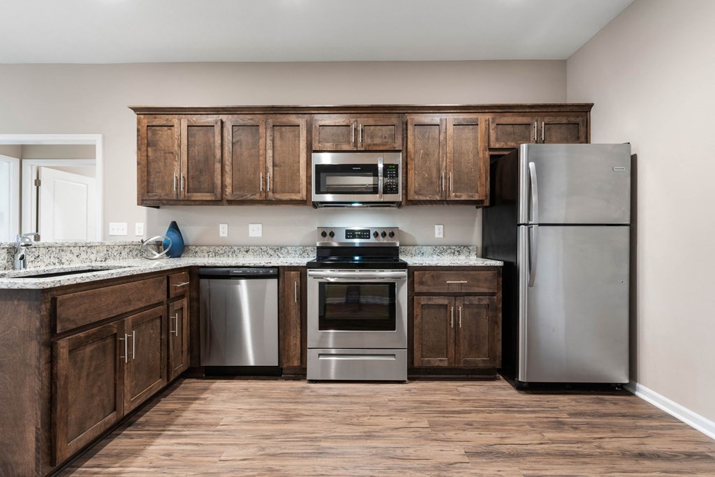a kitchen with stainless steel appliances and wooden cabinets