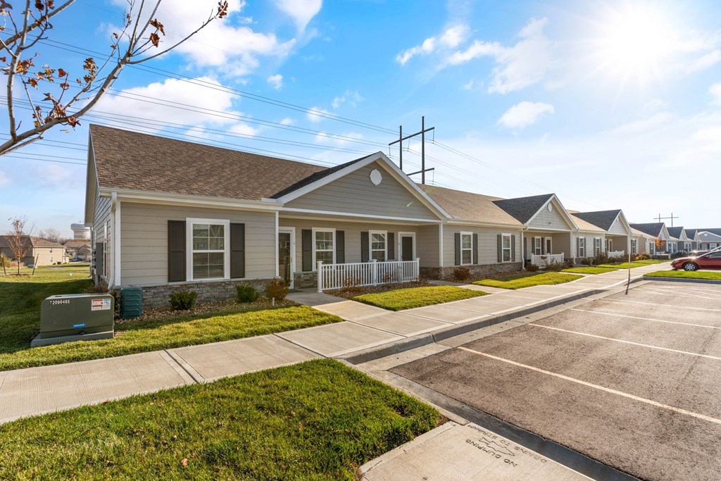 a row of houses on a street with a parking lot