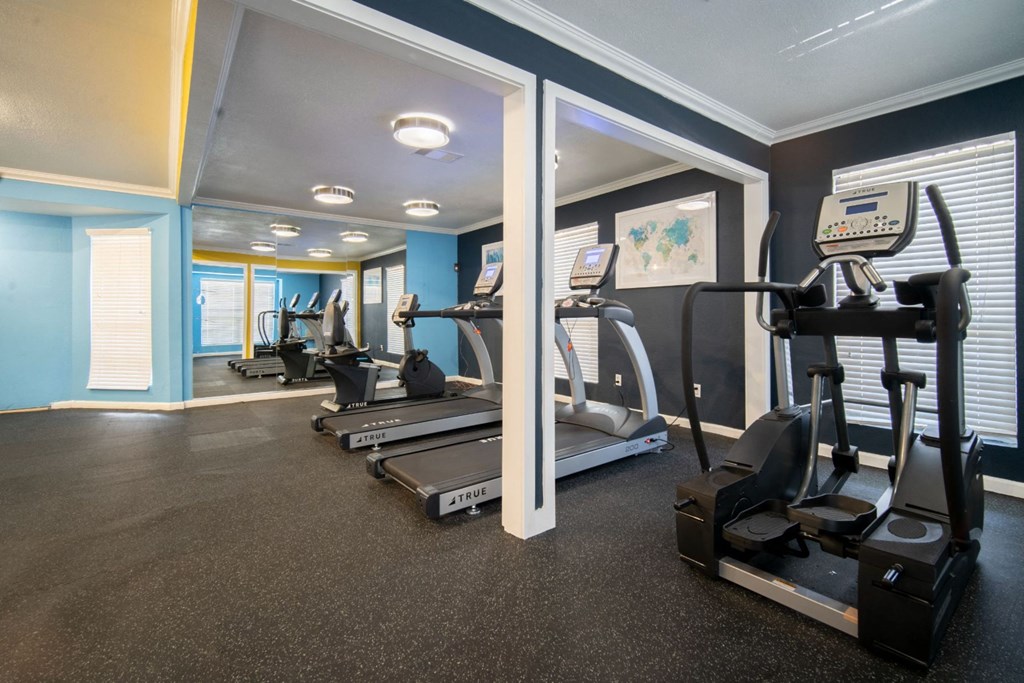 a room filled with lots of different types of exercise equipment