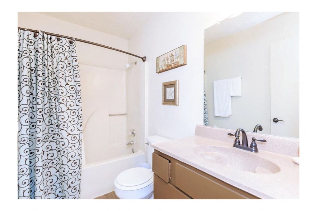a bathroom with a sink toilet and bathtub