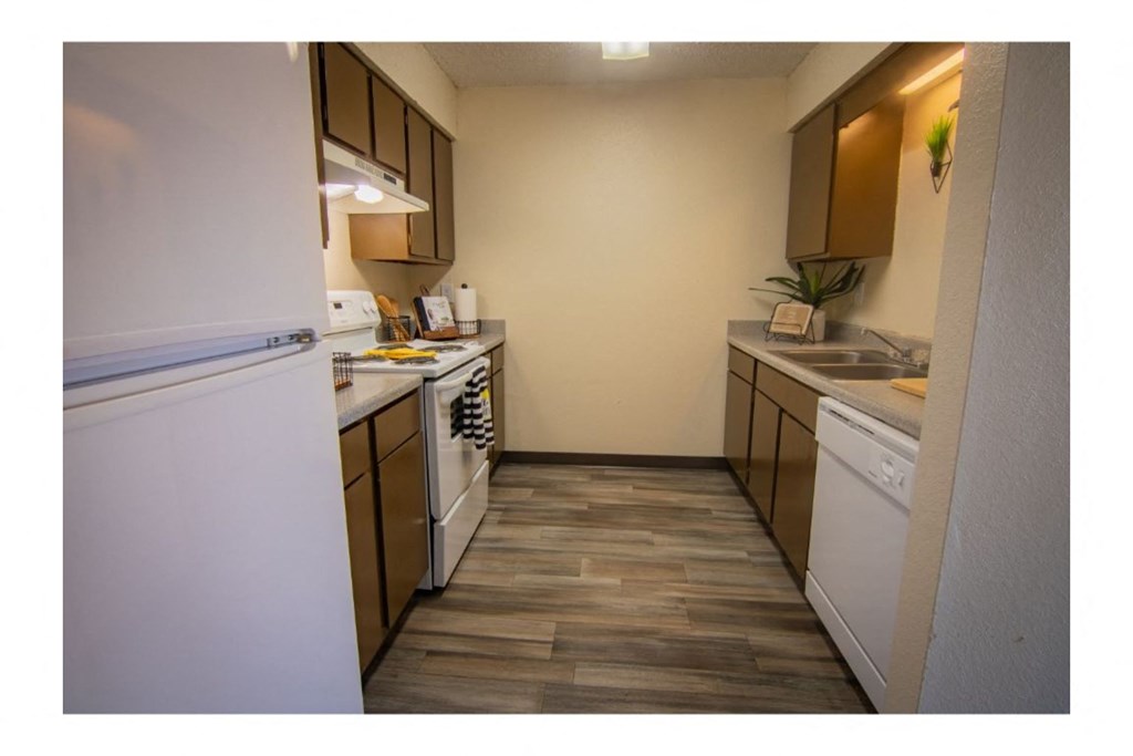 a kitchen with white appliances and brown cabinets