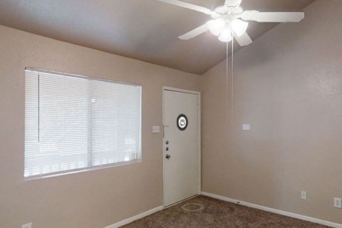 a bedroom with a ceiling fan and a window