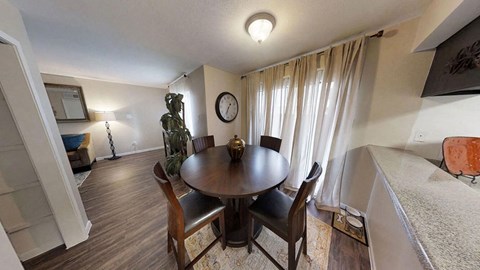 a dining room with a table and chairs