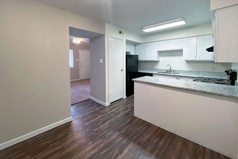 a kitchen and living room at the cornhill landing apartments in rochester, ny