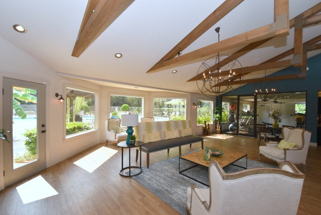 a living room filled with furniture and a large window