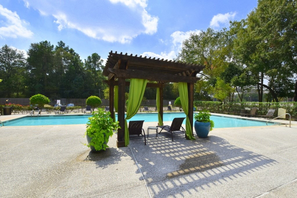 a gazebo next to a swimming pool
