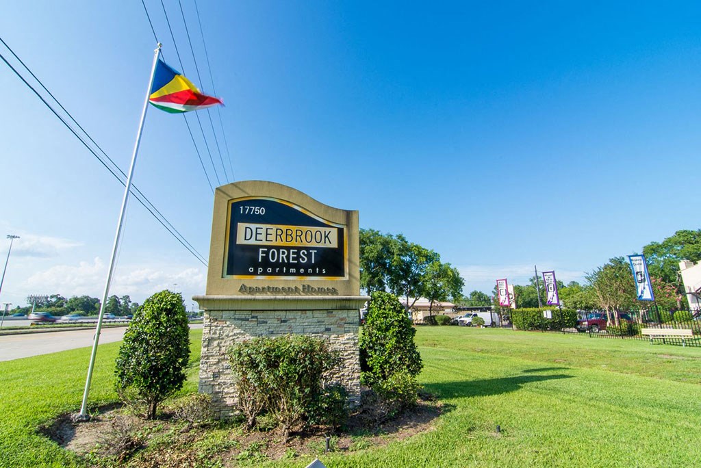 the sign at the entrance of the deerbrook forest shopping center