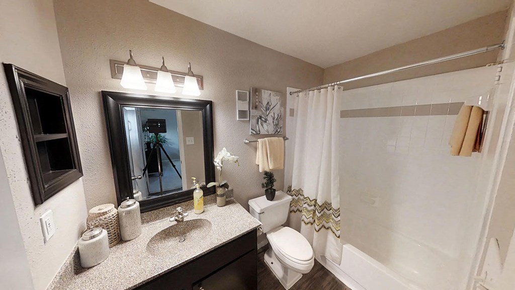 a bathroom with a toilet sink and shower