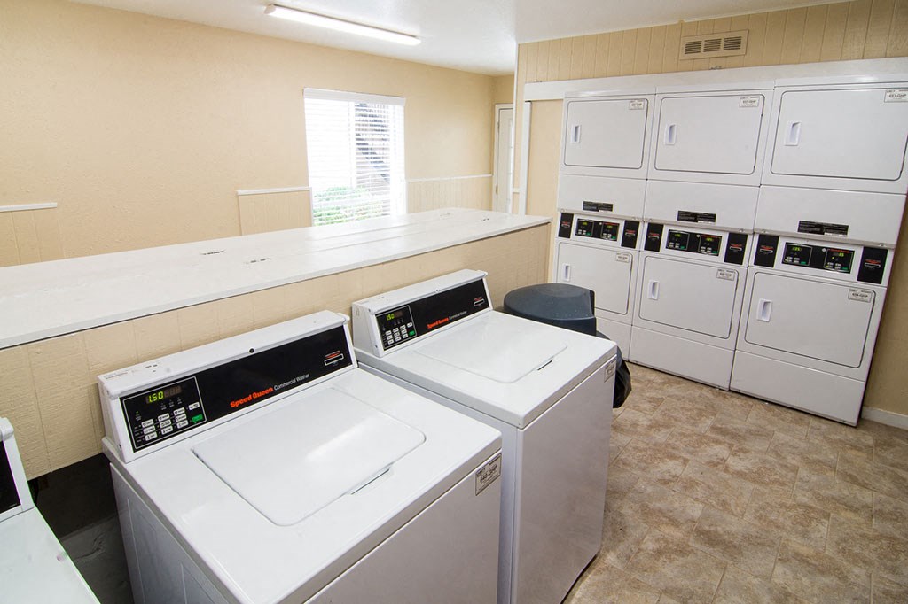 a laundry room with washers and dryers