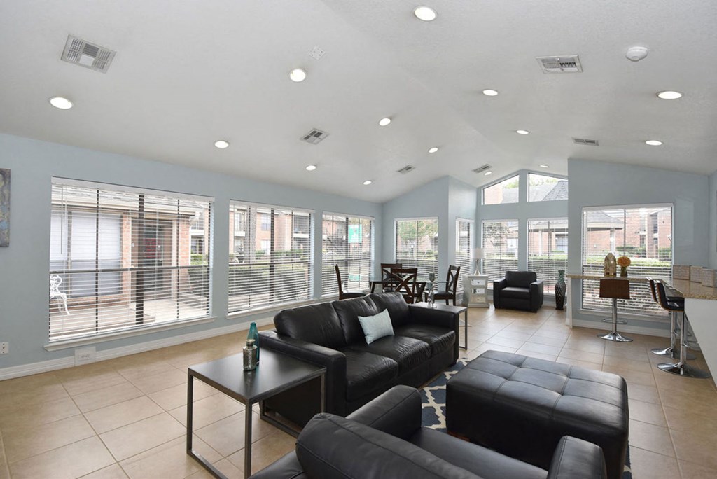 a living room filled with furniture and a large window