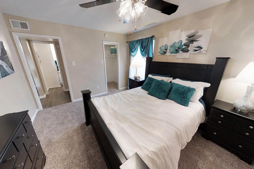 a bedroom with a bed and a chandelier