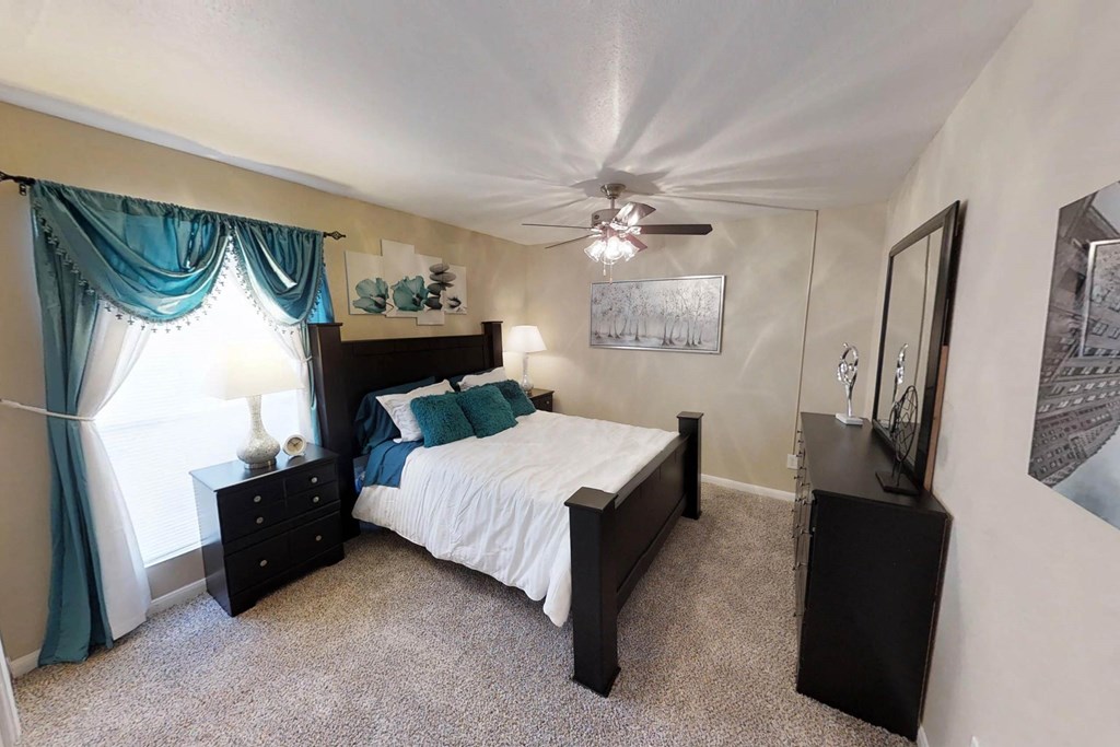 a bedroom with a bed and dresser