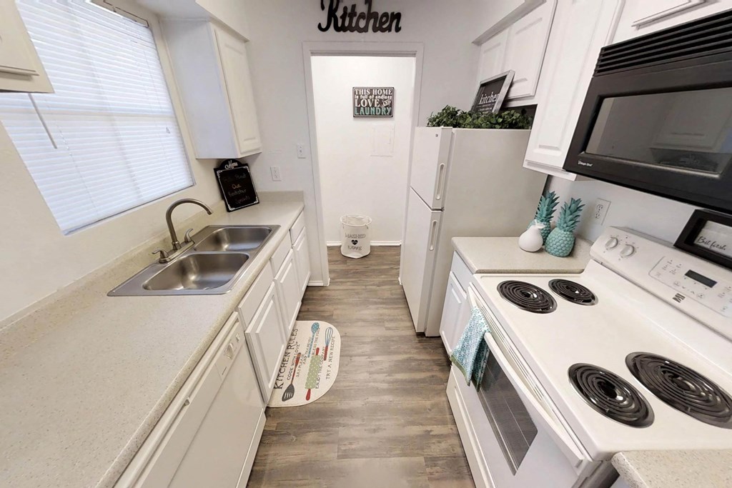 a kitchen with a stove top oven next to a sink
