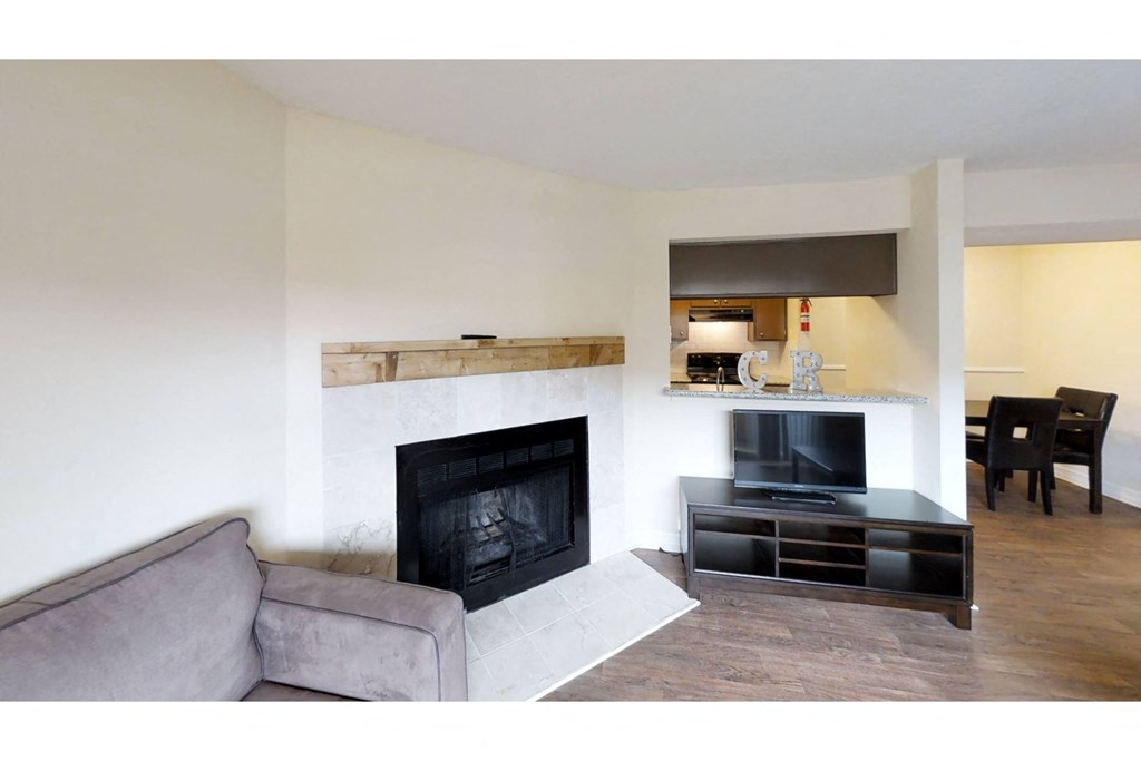 a living room with a fireplace and a tv