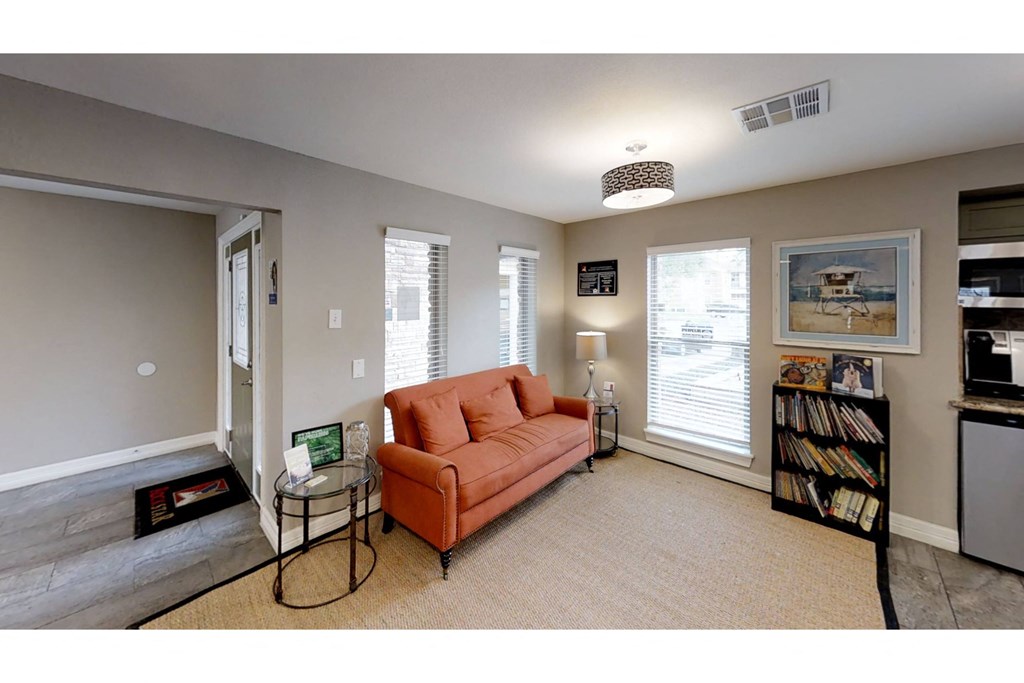 a living room with a couch and two tables