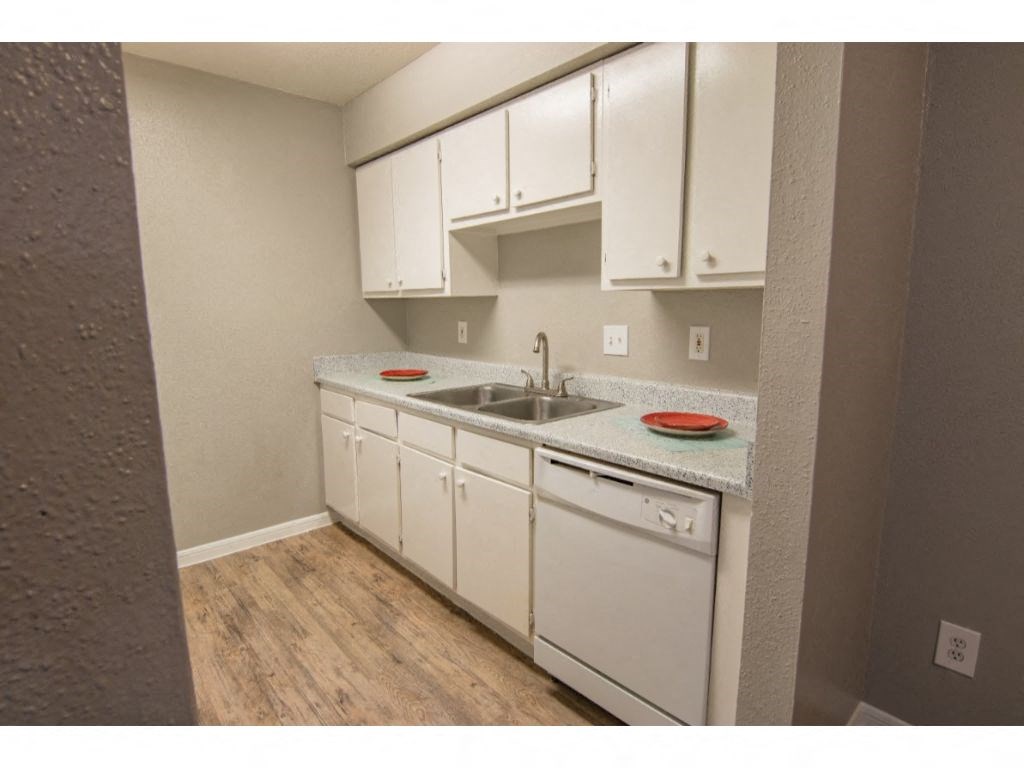 a kitchen with white cabinets and a sink