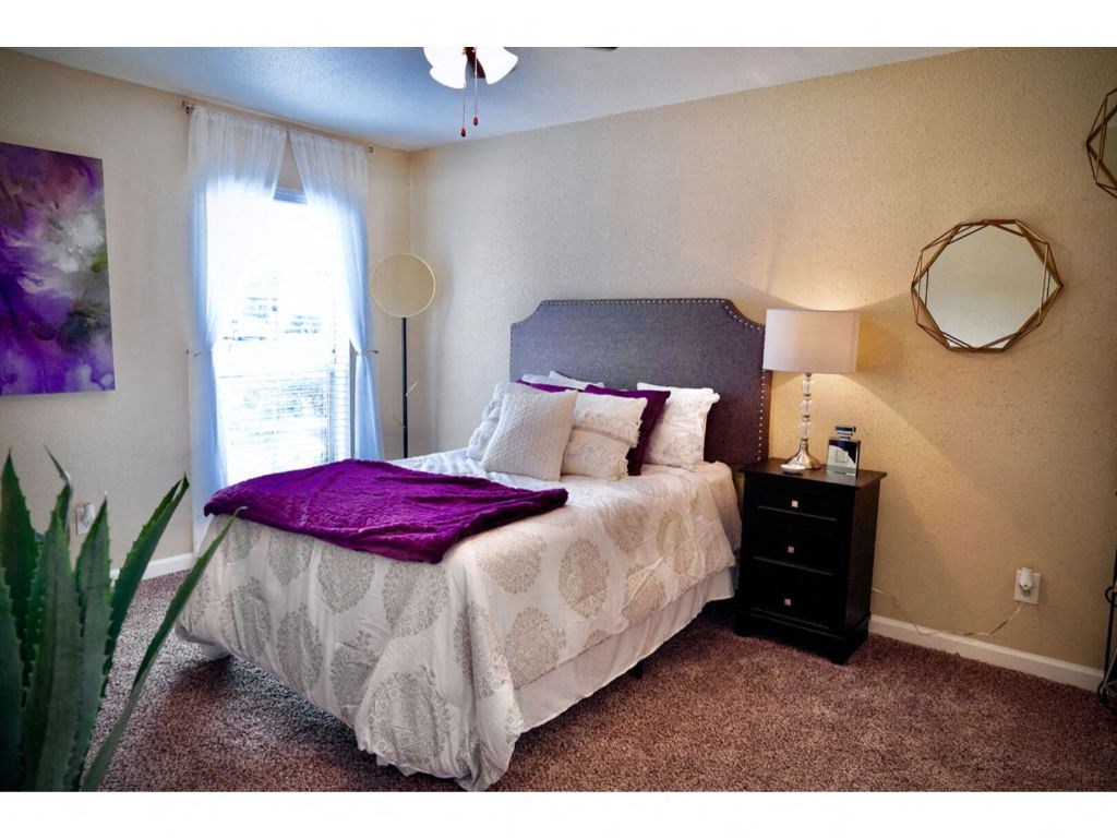 a bedroom with a bed and a nightstand