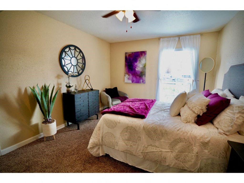 a bedroom with a bed and a dresser