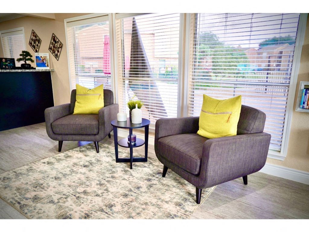 a living room with two chairs and a table