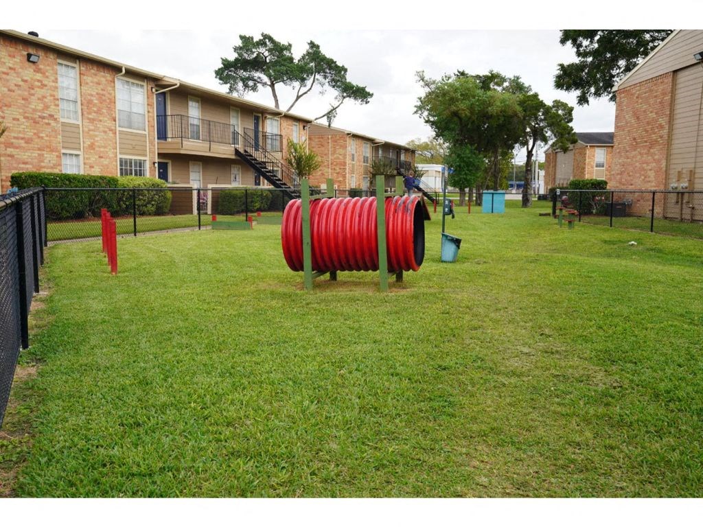 a large yard with a playground in front of a building