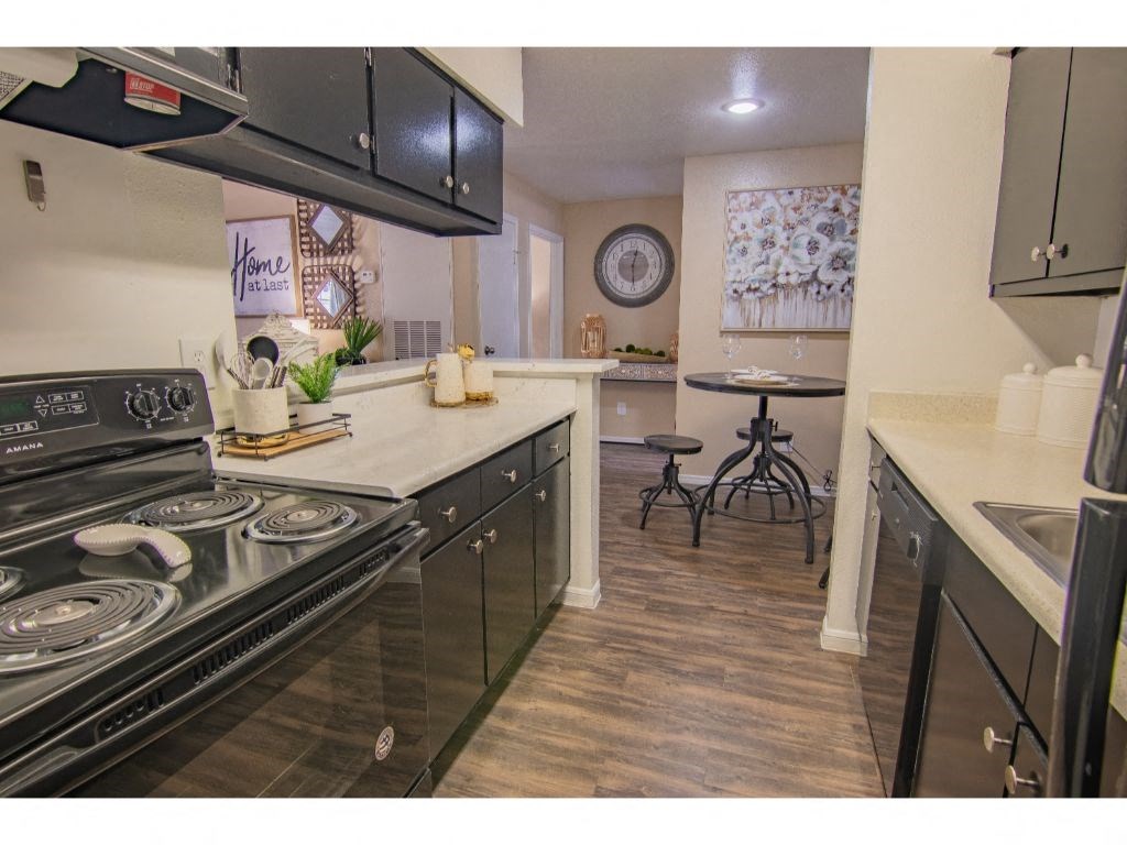a kitchen with a stove top oven next to a counter