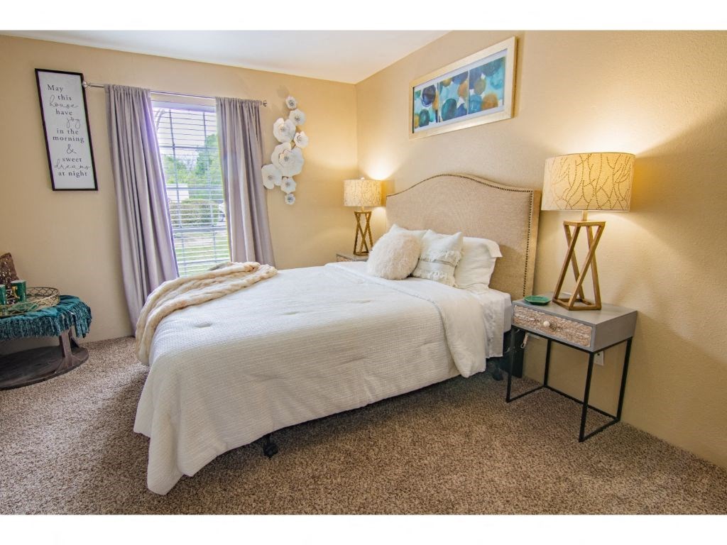 a bedroom with a bed and two lamps