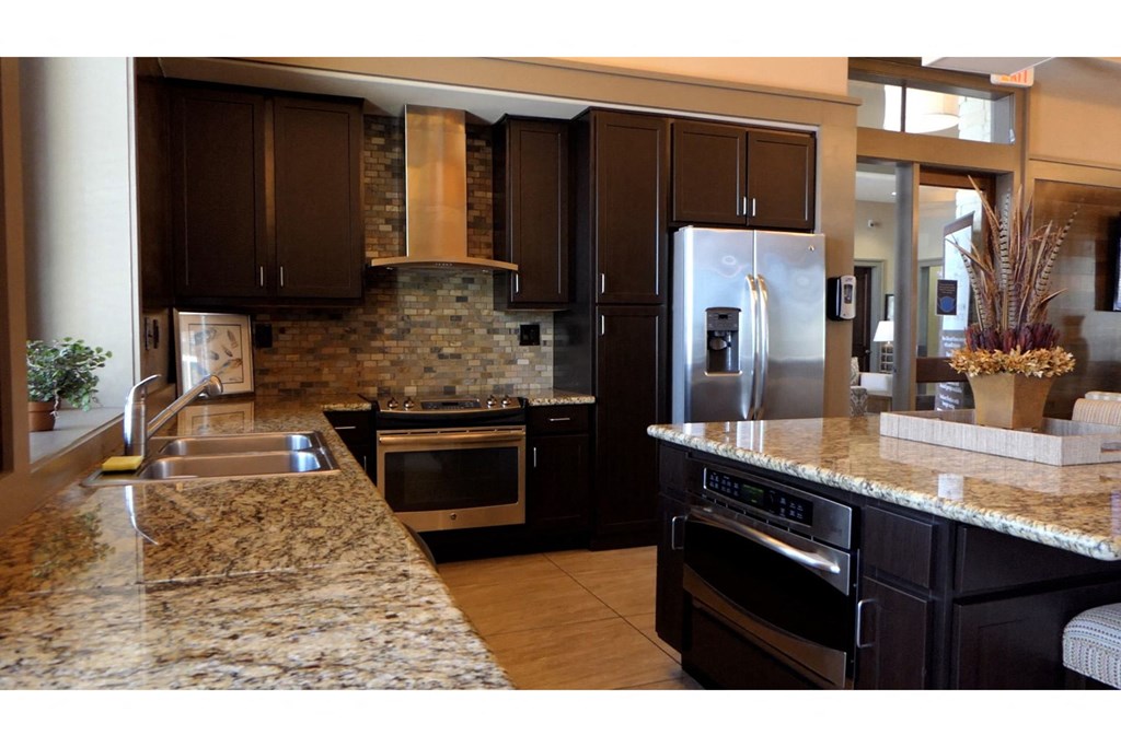 a kitchen with granite countertops and stainless steel appliances