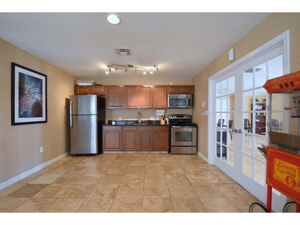 a kitchen with wooden cabinets and stainless steel appliances