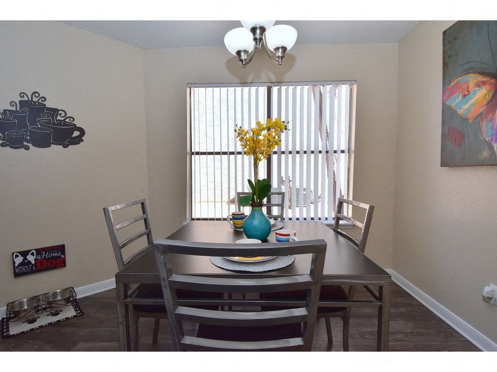 a dining room with a table and chairs