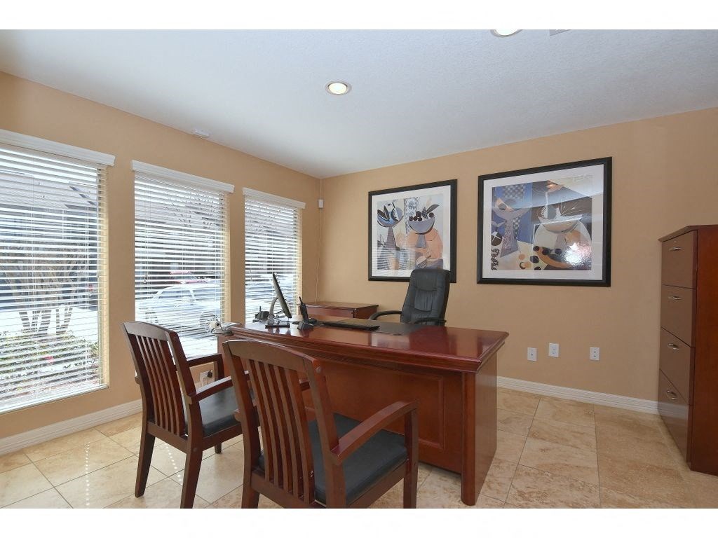a home office with a desk and chairs