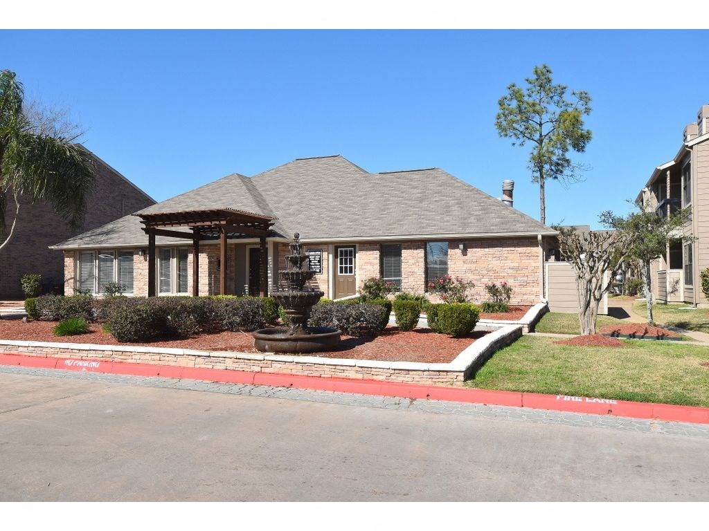 this is a photo of a house with a fountain in the front yard