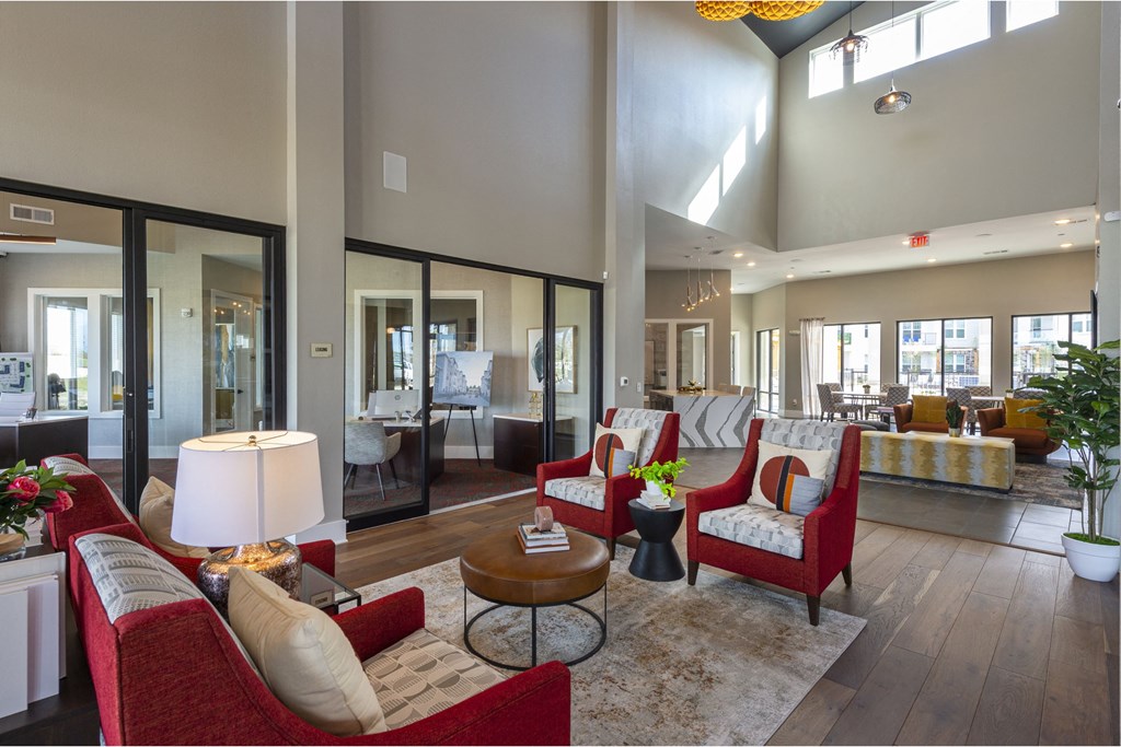 a large living room with red furniture and a large chandelier