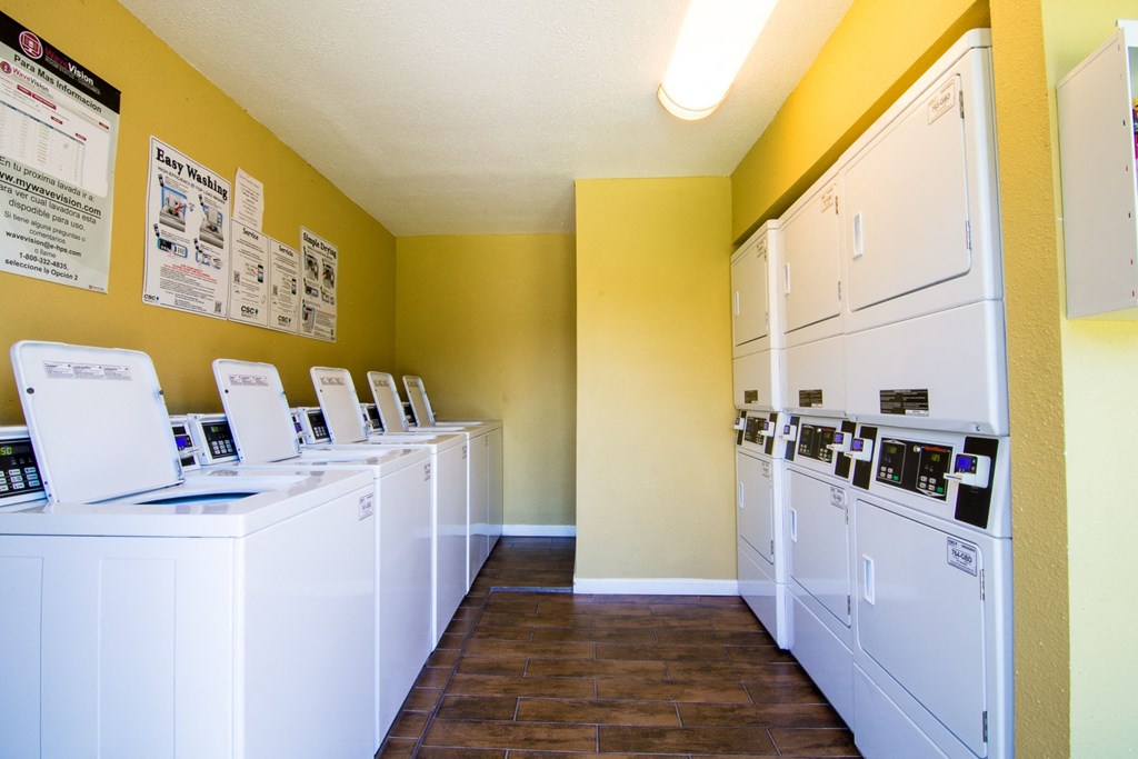 laundry room at the whispering winds apartments in pearland, tx