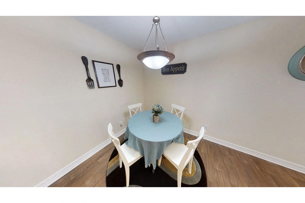 a dining room with a table and chairs