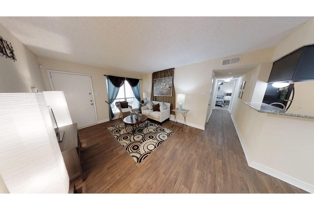 a spacious living room with a couch and a coffee table