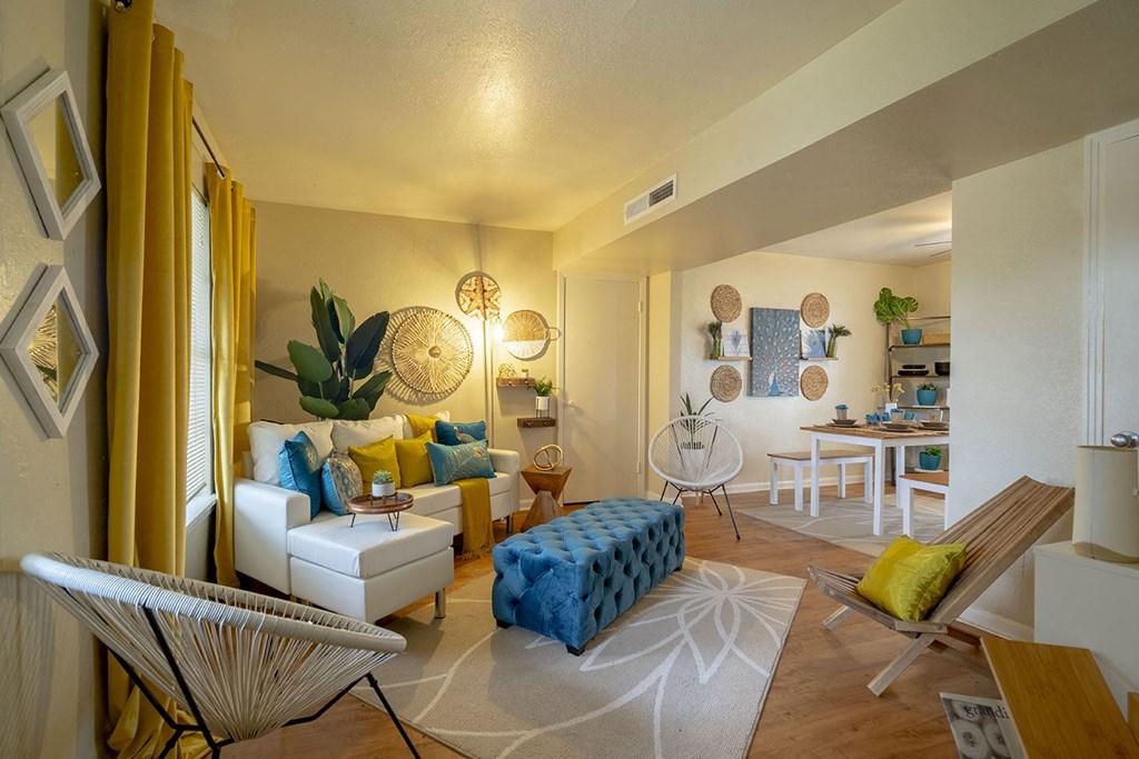 a living room with yellow curtains and blue and white furniture