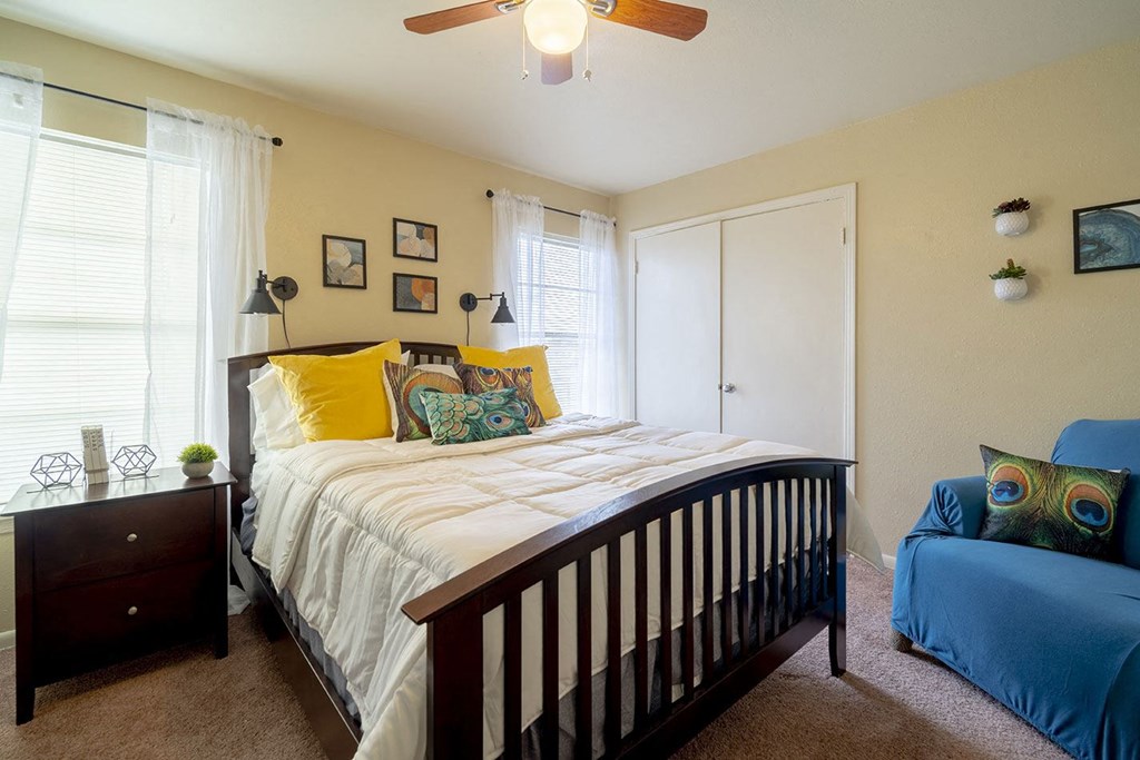 a bedroom with a bed and a chair