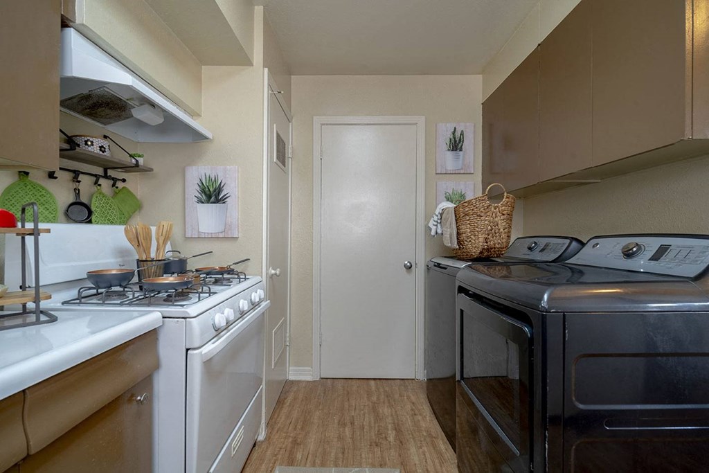 a kitchen with a stove top oven next to a sink