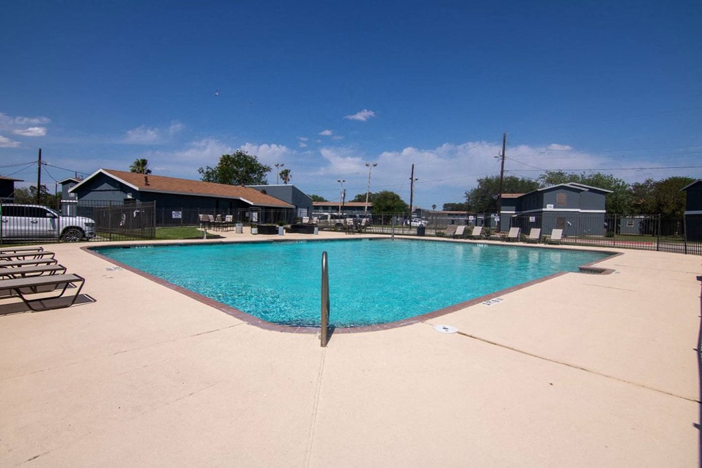 a large swimming pool with a blue sky in the background