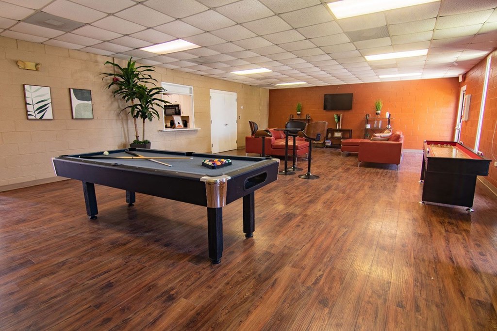 a recreation room with a pool table and a foosball table